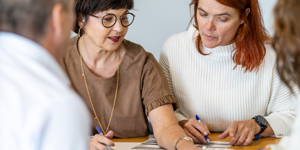4 mennesker taler sammen rundt om et bord